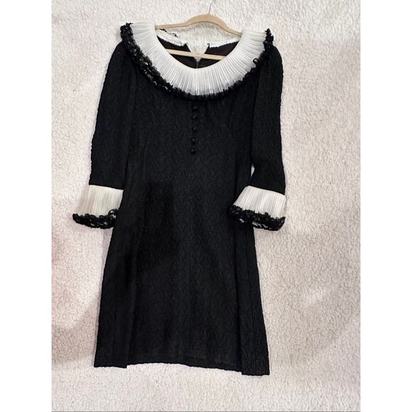 A vintage dress fits a S/M black and white ruffled lace dress with a few elegant